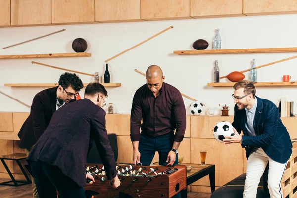 depositphotos 228239238 stock photo multiracial businessmen playing table football